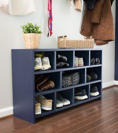 a blue shelf filled with shoes next to a coat rack