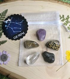 rocks are arranged on a piece of wood with the word gemin written above them