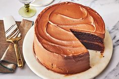 a chocolate cake on a plate with a slice cut out