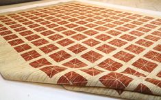 an orange and white area rug sitting on top of a table