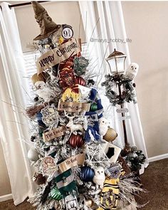 a white christmas tree decorated with harry potter ornaments