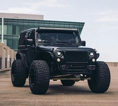 a black jeep parked in front of a building