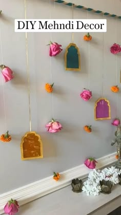 a mantel with flowers hanging from it's sides and decorations on the mantle