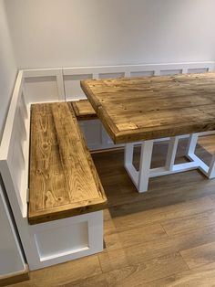 a wooden table and bench in a room