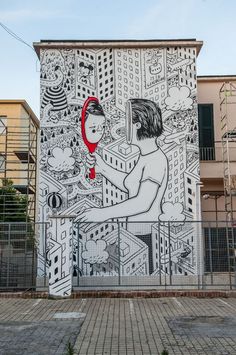 a mural on the side of a building with a woman holding a tennis racquet