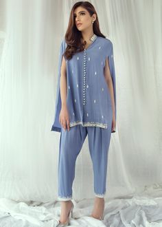 • Sky blue cotton silk handworked cape with resham and mirrorwork details on front and back • Paired with matching skinny shalwar with same work on bottom • Matching inner shirt (Includes Capr, inner shirt and skinny shalwar) Blue Designer Wear Sets With Mirror Work, Blue Cotton Silk Salwar Kameez With Mirror Work, Designer Wear Blue Mirror Work Sets, Designer Blue Mirror Work Sets, Blue Cotton Pant Set With Straight Kurta, Designer Blue Cotton Silk Lawn Suit, Blue Bollywood Style Cotton Silk Lawn Suit, Blue Bollywood Cotton Silk Lawn Suit, Designer Blue Kurta With Mirror Work