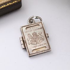 A lovely vintage sterling silver opening British passport charm by Nuvo. This would make a great gift for a charm bracelet, or as a quirky pendant on a chain. A fabulous novelty vintage charm, in wonderful condition. Please be sure to see all of the photos. Stamped for silver and signed to the reverse. Approximate Dimensions: Height - 2cm Width - 1.5cm Weight - 2.6 grams ----------------------- All boxes and stands in the photos are for display purposes only, unless otherwise stated. Please be a Travel Charm Bracelet, British Passport, Mr D, Travel Charms, Gifts Sign, Bracelet Gift, Vintage Charms, Vintage Sterling Silver, Charm Pendant