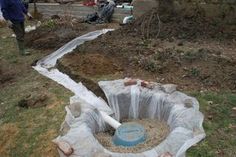 a man standing next to a large hole in the ground