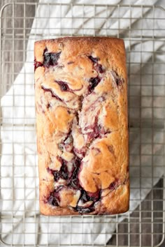 cranberry sauce swirl pound cake on a cooling rack with text overlay that reads, cranberry sauce swirl pound cake