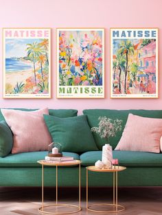 a living room filled with green couches and paintings on the wall above them that say matissee