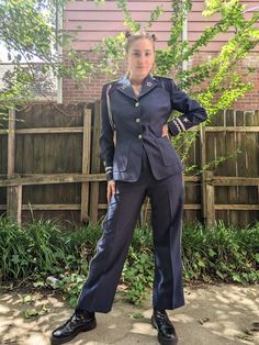 "1970s Navy Blue Military Style Uniform with Silver Decorations. This really fun set is composed of a pair of trousers and a jacket. The trousers have side pockets and close with a zipper and two hooks. They are decorated with silver braid on the sides. The jacket closes with three buttons and is decorated with fringed epaulets on the shoulders, three strands of silver braid under the right epaulet, and silver ric rac and stars around the cuffs. The brand on this set is Alamo Uniforms, although I seriously doubt that this was ever a real uniform. It is in beautiful condition. Jacket Chest: 37\" Waist: 32\" Shoulders: 15.5\" Sleeves: 31\" Length: 27\" Trousers  Waist: 27\" Hips: 40\" Inseam: 29.75\" Rise: 13.5\" Outseam: 41\"" Marines Uniform, Military Suit, Silver Decorations, Women Necktie, Style Uniform, Arlington Va, Womens Suits, Silver Decor, Uniform Fashion