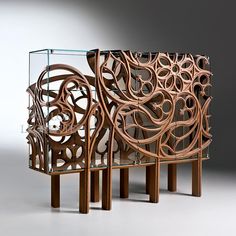 two pieces of art made out of wood and glass with intricate designs on the sides