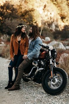 two people are sitting on a motorcycle together