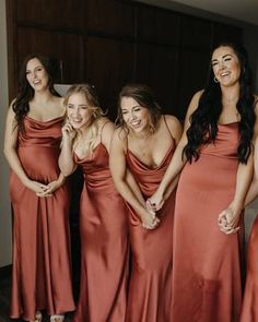 the bridesmaids are laughing together in their dresses