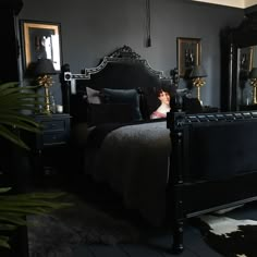 a bedroom with black walls and dark furniture