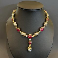 This is part of Chairish’s Fine Jewelry assortment.  Natural Red Ruby 54 Carats South Sea Oval shape Tahiti Pearls Natural Sapphires - 9 Carats 18K Yellow Gold  This Necklace is from the "Baroque" collection and it is the epitome of elegance and versatility and offers a perfect blend for day to night and swimwear to evening wear, allowing you to effortlessly transition between different occasions and outfits. Wearing this will undoubtedly make you the center of attention. It has a rich history g Pearl And Ruby Necklace, Luxury Red Cabochon Necklaces, Luxury Red Cabochon Necklace, Luxury Ceremonial Ruby Jewelry, Luxury Ruby Jewelry For Ceremonial Occasions, Ceremonial Luxury Ruby Jewelry, Luxury Ruby Jewelry With Rose Cut Diamonds, Traditional Cabochon Necklace For Formal Occasions, Designer Red Jewelry For Anniversary