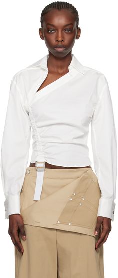 Stretch cotton-blend poplin shirt. Ruching throughout. · Offset pointed collar · Adjustable cinch strap at front · Concealed zip closure at side seam · Pleats at cuffs · Detachable logo-engraved graphic cufflinks Supplier color: Ivory White Collar Top Outfit, Neckline Finishing Ideas, Asymmetrical Button Down Shirt, Fashion Trend 2025, Runaway Shirt, Reconstructed Shirt, Asymmetrical Clothes, Detachable Clothing, White Shirt Fashion