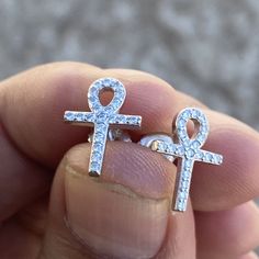 Men's and women's Ankh cross stud earrings set. Genuine solid 925 sterling silver precious metal. Real 925 earrings are stamped with "925". Solid earrings weigh approx. 1.5 grams a pair. Nicely iced with dazzling micro pave CZ gems. Cross measures 14MM tall x 10MM wide. Real 925 jewelry that won't turn your ears green. You can take a shower with these earrings on. Buy with confidence with our 30-day returns. Enjoy 100% FREE SHIPPING in USA. Order now! Sterling Silver Piercings For Anniversary, Silver Ankh-shaped Pierced Jewelry, Silver Ankh Shaped Pierced Jewelry, Silver Ankh Pierced Jewelry, Silver Ankh Shaped Pierced Earrings, Silver Cubic Zirconia Plug Earrings For Gift, Pierced Silver Ankh Jewelry, White Gold Cross Earrings For Gift, Silver Ankh Earrings