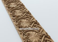 an intricately carved wooden panel with scrolls and flowers