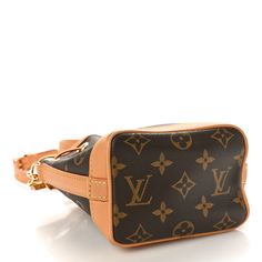 This is an authentic LOUIS VUITTON Monogram Nano Noe NV. This stylish Louis Vuitton bucket handbag is crafted of traditional Louis Vuitton monogram on coated canvas. This bag features signature vachetta leather, a cinch cord, and piping with gold plated hardware. The top opens to a cocoa brown microfiber interior. Louis Vuitton Noe Bag, Louis Vuitton Monogram Bag, Bucket Handbags, Louis Vuitton Empreinte, Cocoa Brown, Mini Pouches, Lv Monogram, Monogram Bag, Louis Vuitton Shoulder Bag