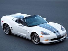 a white sports car with black stripes on it