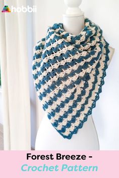 a blue and white crochet shawl with text reading forest breeze - crochet pattern