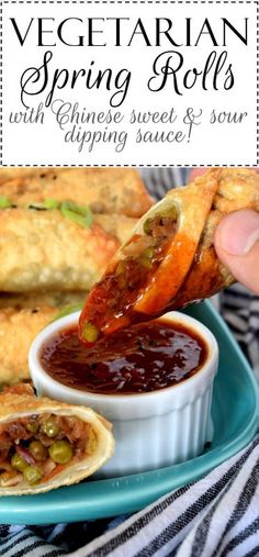 a person dipping some food into a small bowl with sauce on it and the words vegetarian spring rolls