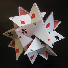 an origami star made out of playing cards with hearts and spades on them