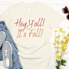 Hey Y'all!  It's Fall!  Cute and simple T-shirt with 2 toned print to make the words stand out.  This basic tee is perfect for fall.  This is an original Fall design which I created, so you will only find it here in my shop. The Gildan 64000 softstyle Unisex Sized T-shirt is very soft, durable and comfortable. * Solid colors are 100% ring-spun cotton * Sport Grey is 90% ring-spun cotton, 10% polyester * Dark Heather is 65% polyester, 35% cotton * Fabric weight: 4.5 oz/yd² (153 g/m²) * Regular Un Fall Graphic Tee With Funny Text, Fall Casual T-shirt With Funny Text, White Tops With Funny Text For Fall, White Funny Text T-shirt For Fall, Antique Silver Earrings, Hey Yall, Its Fall, Fall Country, Fall Yall