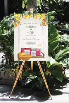 an easel with a sign that says welcome to mehndi and handi