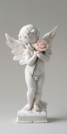 a white angel statue holding a pink rose