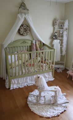 a baby's room with a rocking horse on the floor and crib in the corner