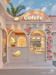 a coffee shop with pink roses on the front and side walls, decorated in gold