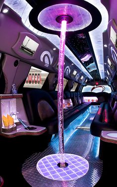 the inside of a bus with purple lights