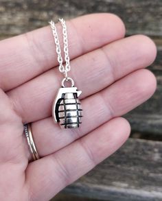 "This silver colored necklace has a grenade charm. The charm measures 7/8\" x 1/2\". All jewelry comes in a gift box. *Choose your necklace length at checkout. These make awesome gifts! Especially anniversaries, weddings, birthdays, holidays, and Christmas." Sterling Silver Dog Tag Jewelry For Gift, Nickel Free Silver Charm Necklaces As Gift, Nickel-free Silver Charm Necklaces For Gifts, Sterling Silver Dog Tag Jewelry Gift, Nickel-free Silver Charm Necklaces As Gift, Silver Charm Necklace For Birthday Gift, Silver Charm Necklace For Birthday With Lobster Clasp, Adjustable Box Chain Charm Necklace For Gift, Silver Dog Tag Necklace For Gift