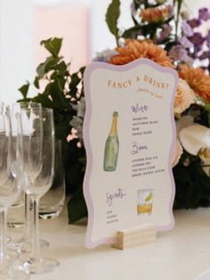 a table topped with lots of wine glasses next to a sign that says fancy a drink