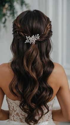 a woman wearing a bridal hair comb with flowers on it's head and long brown hair