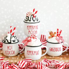 three mugs with hot cocoa and peppermint mocha in them on a table