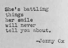 an old typewriter with the words she's battling things her smile will never tell you about