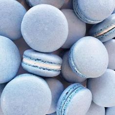 several macaroons are stacked on top of each other in blue and white colors