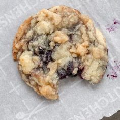 a blueberry crumb cookie on top of a piece of paper with writing underneath it