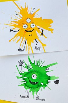 two children's handprints with green and yellow paint on them