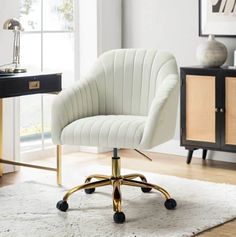 a white office chair with gold wheels on a rug in front of a desk and window