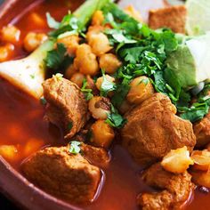 a bowl filled with meat, beans and cilantro