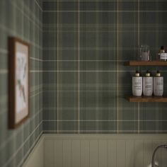 a bathroom with green plaid wallpaper and wooden shelves