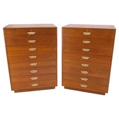 a pair of wooden drawers with brass handles