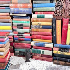 a stack of books sitting on top of a white doily