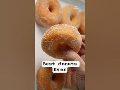 a person is holding two donuts in front of them with the caption best donuts ever