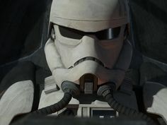 a star wars character wearing a helmet and holding a radio in front of his face