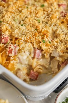 a casserole dish with ham, cheese and pasta in it on a table